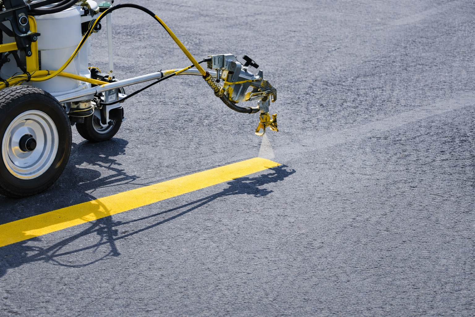Technician performing parking lot striping and line painting in South Florida